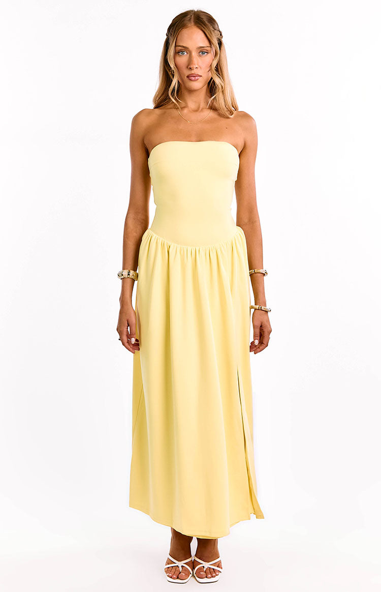 Yellow strapless maxi dress with a fitted bodice, gathered waist, and a long flowy skirt with a side slit