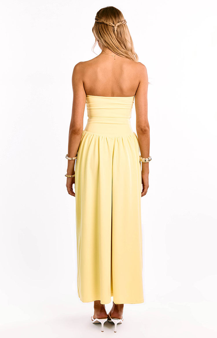 Rear view of a yellow strapless maxi dress with a fitted bodice, gathered waist, and a long back split