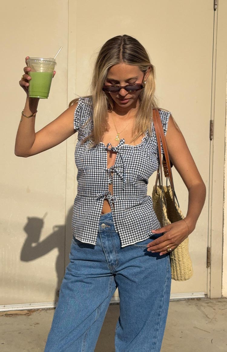 Cropped black gingham tie-front top with multiple ties, a square neckline, and ruffled cap sleeves