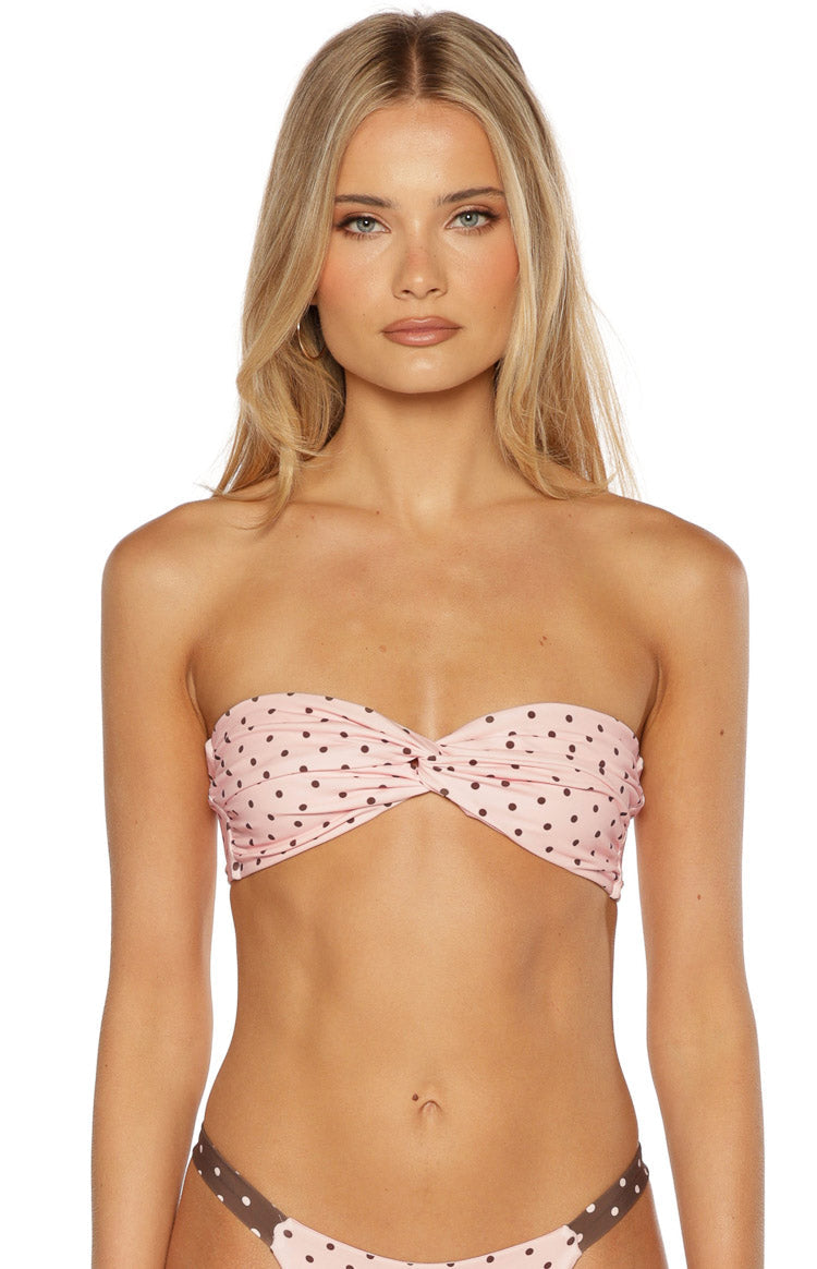 Close up of a pink polka dot strapless bikini top with a twist front detail cute for a pool day