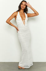 White lace halter maxi dress with a deep V-neck and tie-front, featuring a fitted silhouette and intricate lace