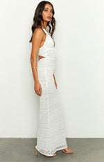 Side profile of a white lace maxi dress with a halter neckline and waist cutouts
