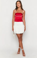 White mini bubble skirt featuring a wide flat waistband and voluminous gathered hem