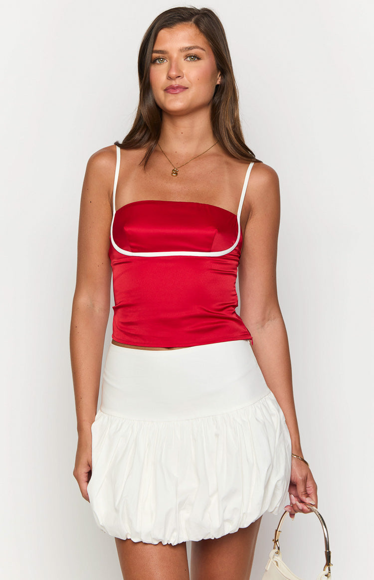 White mini skirt with a wide flat waistband and a voluminous gathered bubble hem