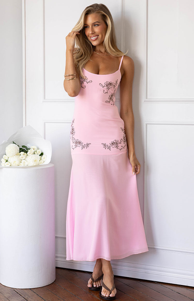 Light pink midi dress with thin spaghetti straps, brown floral embroidery on the bodice, and a flowy skirt