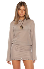 Brown sheer mesh mini dress with a round neckline, long sleeves, and square stud details on the hem