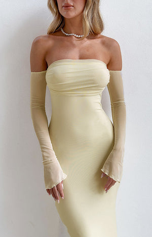 Close-up of the cream strapless maxi dress with ruched mesh bodice and sheer detached long sleeves with frilled cuffs