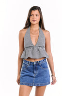 The back view of a black and white gingham halter top- showcasing an open back with a tied neck closure and a ruffled peplum hem.