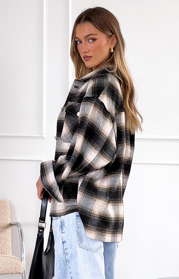 Black, grey, and beige check fleece jacket with a relaxed fit, collared neckline, and two chest pockets