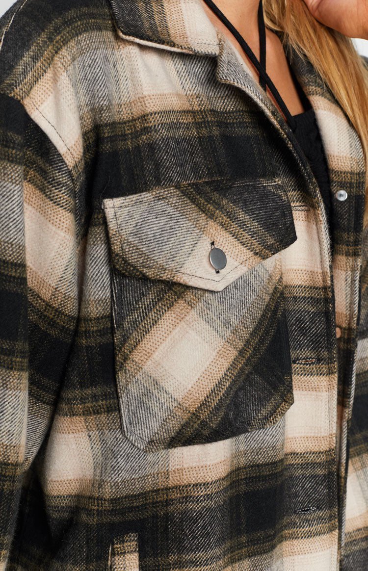 Soft black, beige, and grey plaid fleece jacket with a relaxed fit, back yoke, and buttoned cuffs