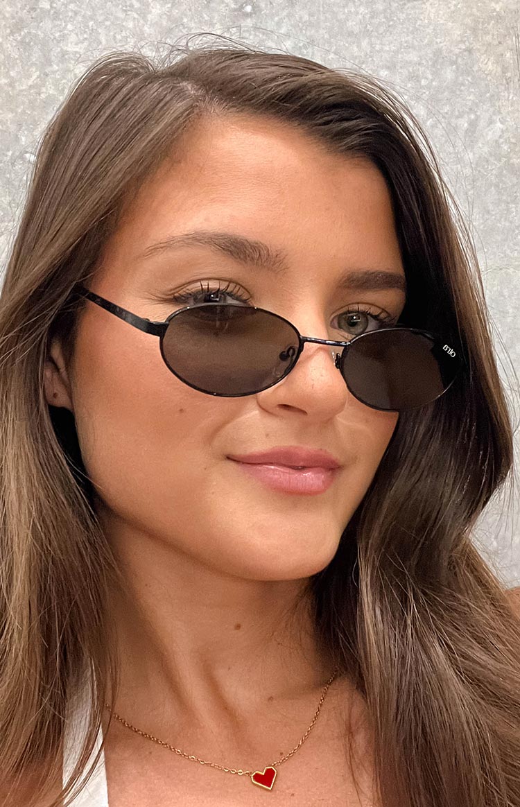 Beginning Boutique Otra Eyewear Rosie Black Oval Sunglasses black oval sunglasses with thin frames and dark lenses
