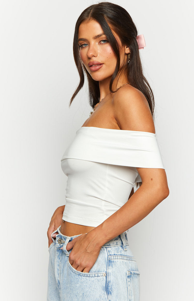 Side view of the white off-shoulder crop top with a wide folded neckline and fitted, cropped hem