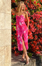 Full length view of a pink and white floral print midi dress with a high side split and drawstring bodice