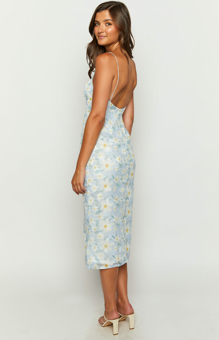 Side view showing the low scoop back and thin spaghetti straps of the light blue floral midi dress