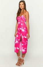 Side view of a pink floral print midi dress with a front thigh-high slit and ruched bust detail
