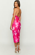 Side view of a pink and white floral print midi dress with a low scoop back and thin spaghetti straps