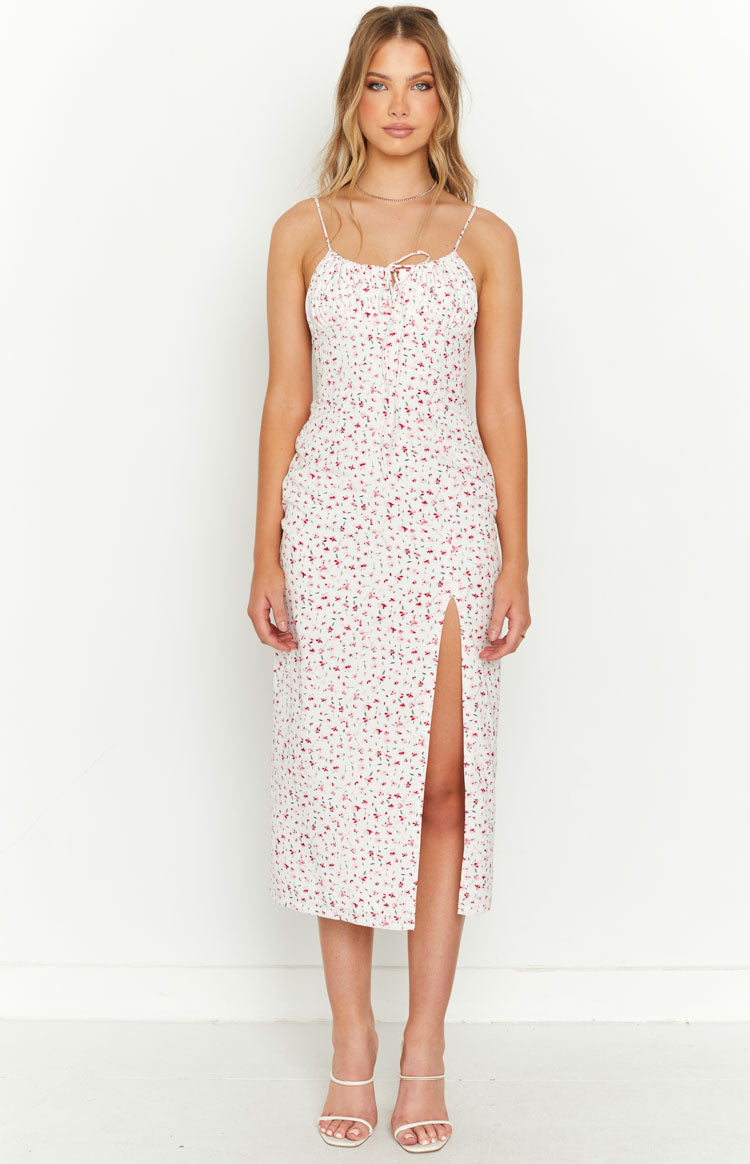White floral midi dress with spaghetti straps, tie-front ruched bust, and a high side slit