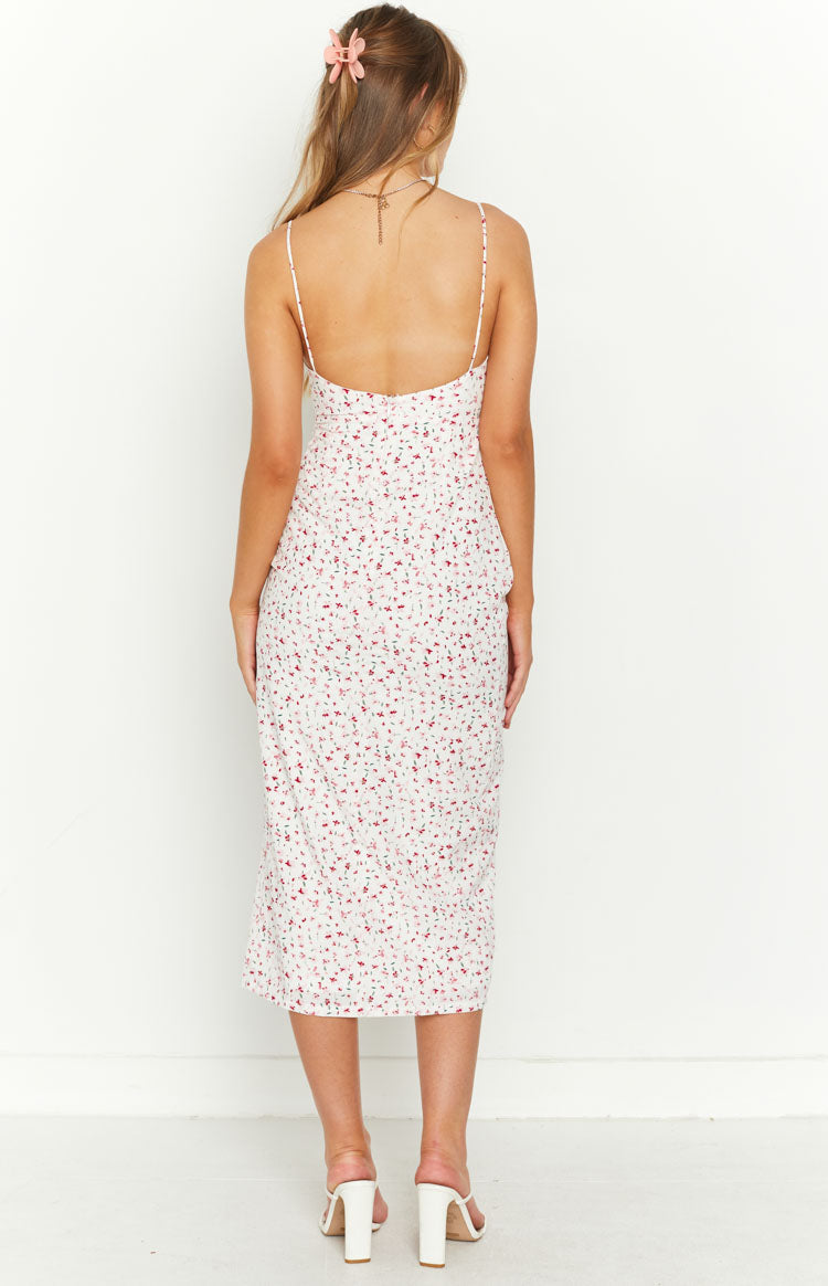 Rear view of a white floral midi dress with a low scoop back and thin spaghetti straps