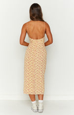 Rear view of a yellow floral midi dress with pink and blue flowers, thin spaghetti straps, low scoop back, and invisible zipper