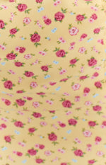 Close-up of the yellow floral midi dress fabric with pink and red roses and small blue flowers