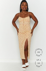 Front view of a yellow floral midi dress with a high leg split and ruched tie-front bust