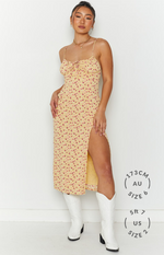 Front view of a yellow floral midi dress with a tie-front sweetheart neckline and high thigh split