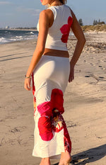 Rear-side view of the white maxi skirt with a large red orchid print on the back and lower side