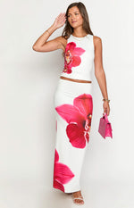 Front view of a white bodycon maxi skirt featuring a large vibrant pink orchid print