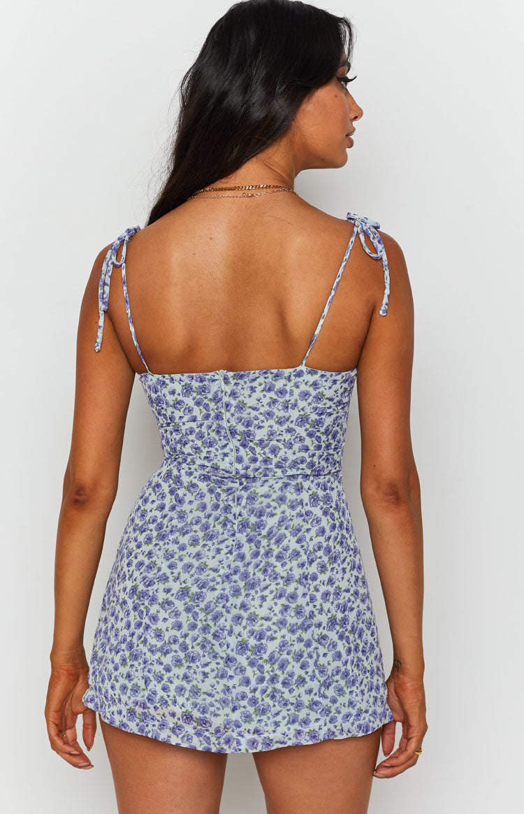 Light blue floral mini dress with tie-up shoulder straps, shirred back, and a back zipper