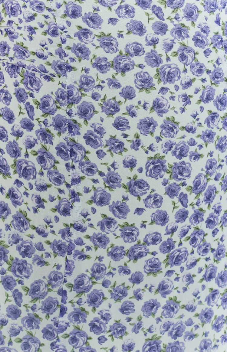 White fabric with a dense pattern of small purple roses and a central stitched seam