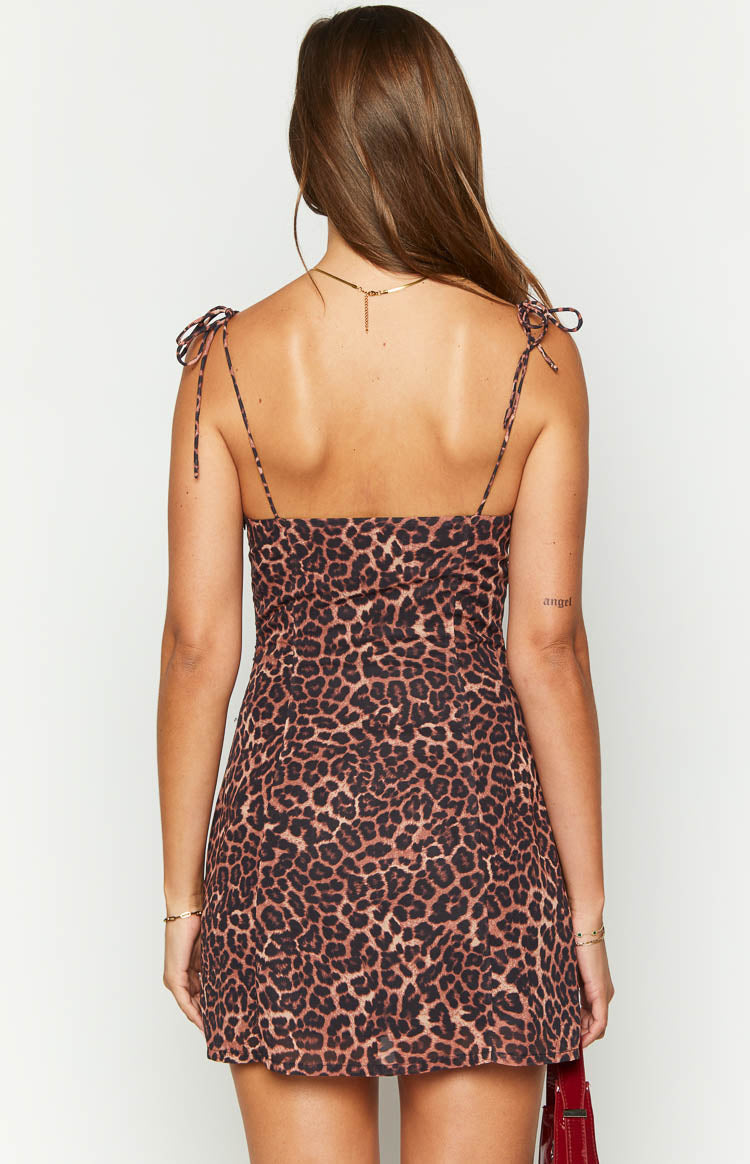 Rear view of a brown and black leopard print mini dress with adjustable tie-shoulder spaghetti straps