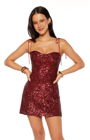 Red sequin mini dress with a sweetheart neckline, self-tie spaghetti straps, and geometric sequin pattern