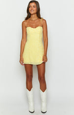 Yellow sequin mini dress with a sweetheart neckline and thin tie-up spaghetti straps