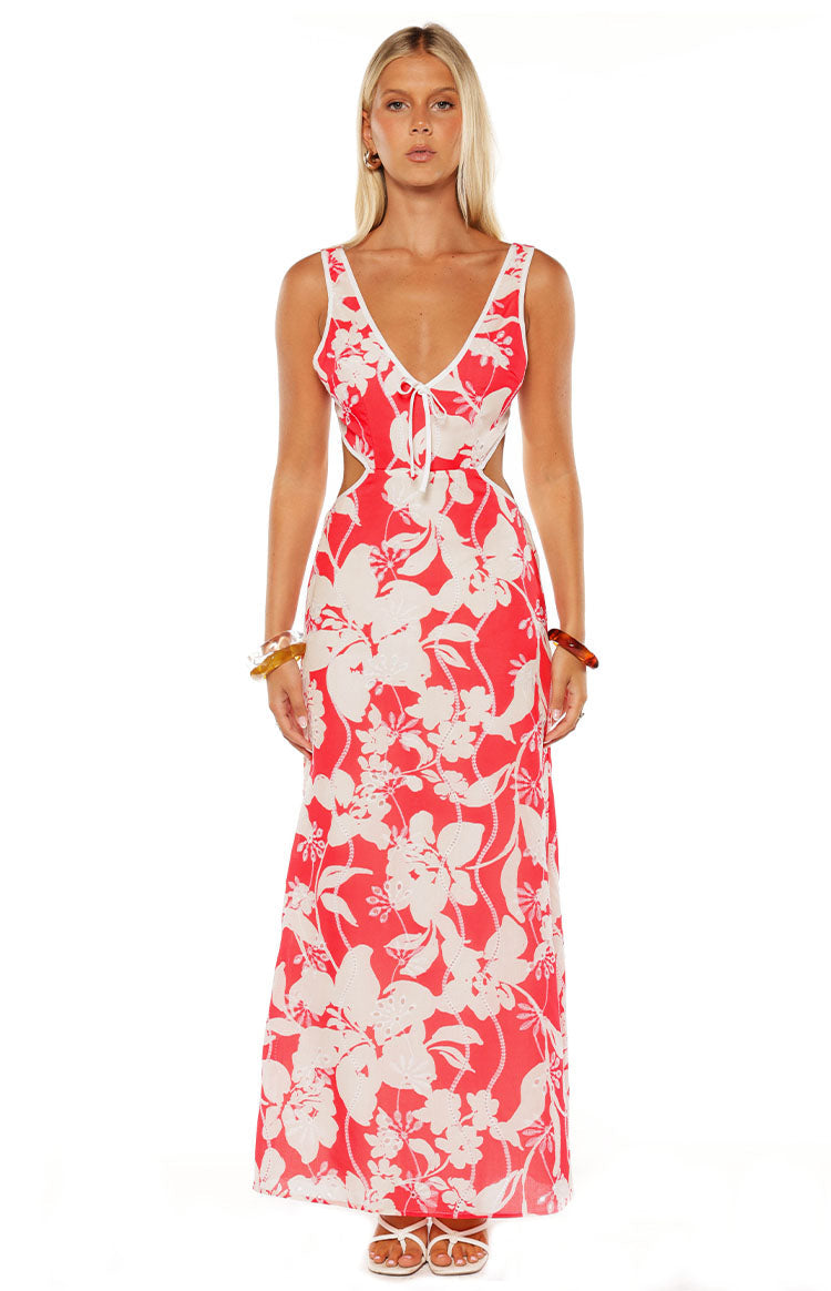 Front view of a red and white floral maxi dress with a V-neck, tie detail, and side waist cutouts