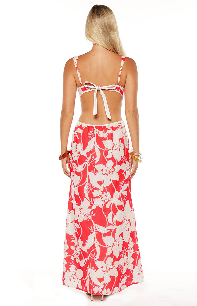 Rear view of the red floral maxi dress with a white tie-back and large open back cutout