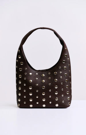 A brown leather-like hobo bag decorated with numerous silver studs of varying sizes across the front