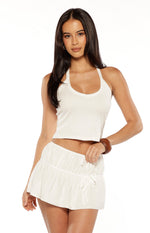 White ruched mini skirt with multiple adjustable tie details at the front