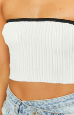 Close-up of the white ribbed knit tube top showing the black contrast bind and cropped hem