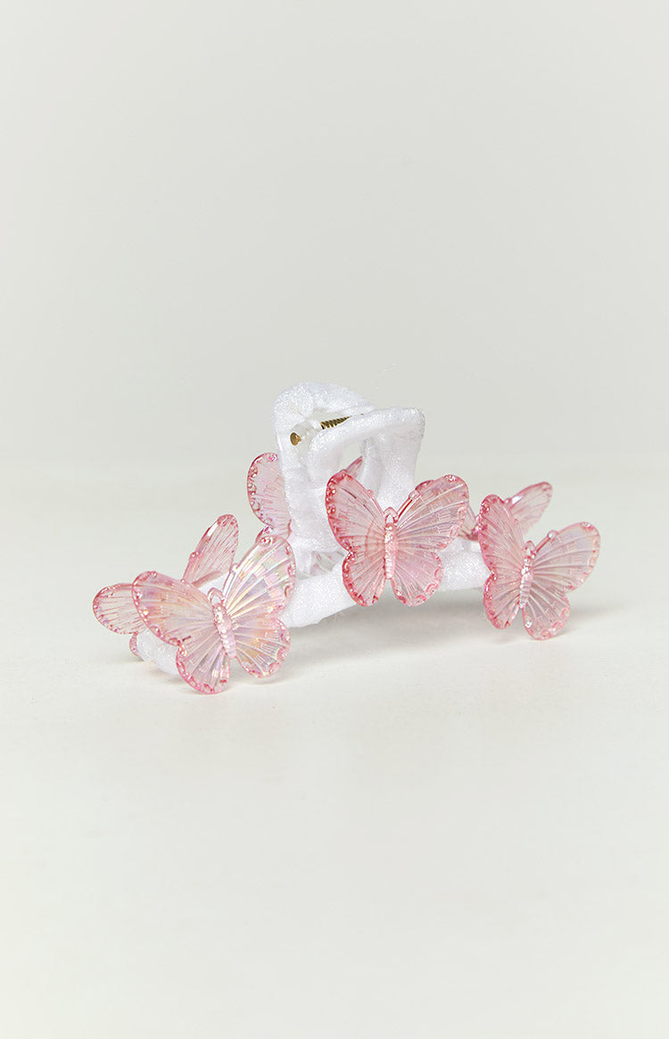 Close-up of the white textured claw clip adorned with multiple pink iridescent butterflies with detailed wings