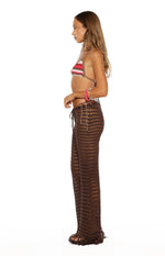 Side view of brown high-waisted crochet pants with drawstring waist, side lacing, and fringed hem