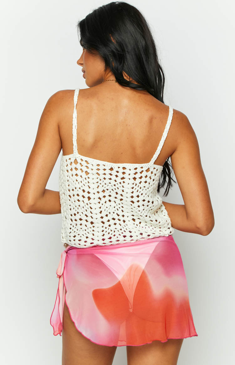 Rear view of the cream open-knit top featuring a wide square back and thin woven straps