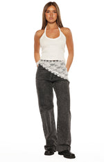 White lace triangle scarf draped diagonally over the hip, showing the intricate floral lace pattern and scalloped edge