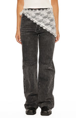 White lace triangle scarf tied at the left hip, showing the scalloped edge and floral pattern