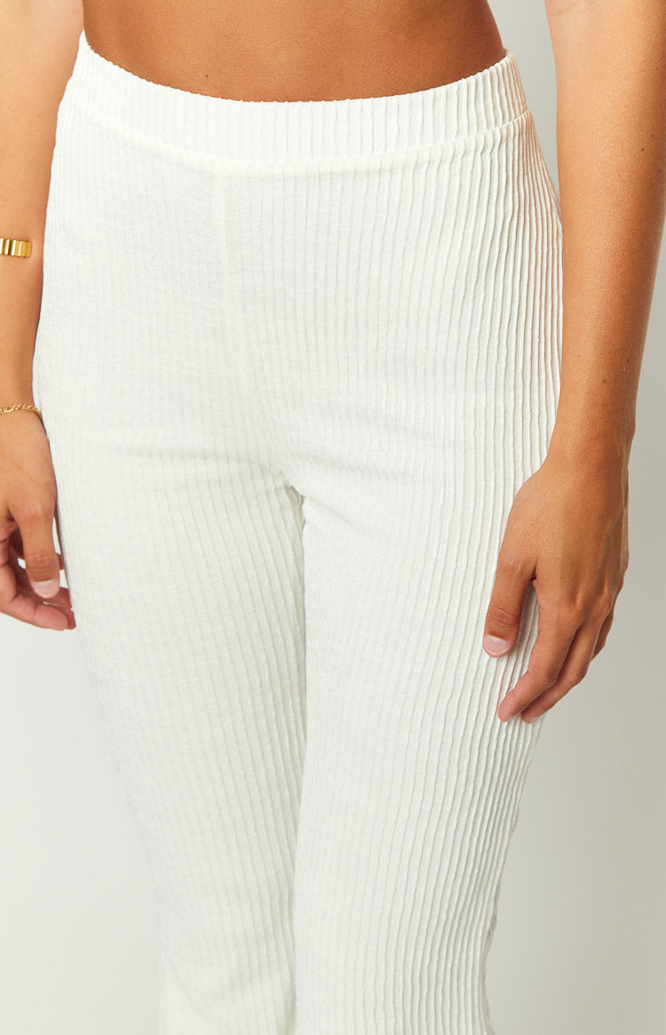 Close-up of the white ribbed knit pants, highlighting the textured fabric and flat elastic waistband
