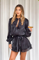 Black satin mini dress with a deep V-neck, long voluminous sleeves, self-tie waist, and tiered ruffled skirt