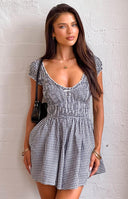 Beginning Boutique Raldo Black Gingham Playsuit black gingham V-neck playsuit with ruched bust, short puff sleeves, and flare