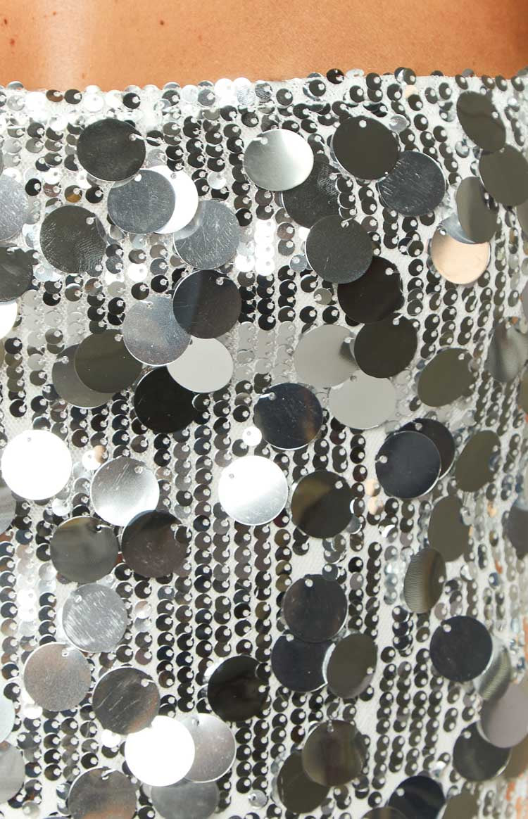 Fitted silver sequin mini dress with a straight neckline and delicate spaghetti straps