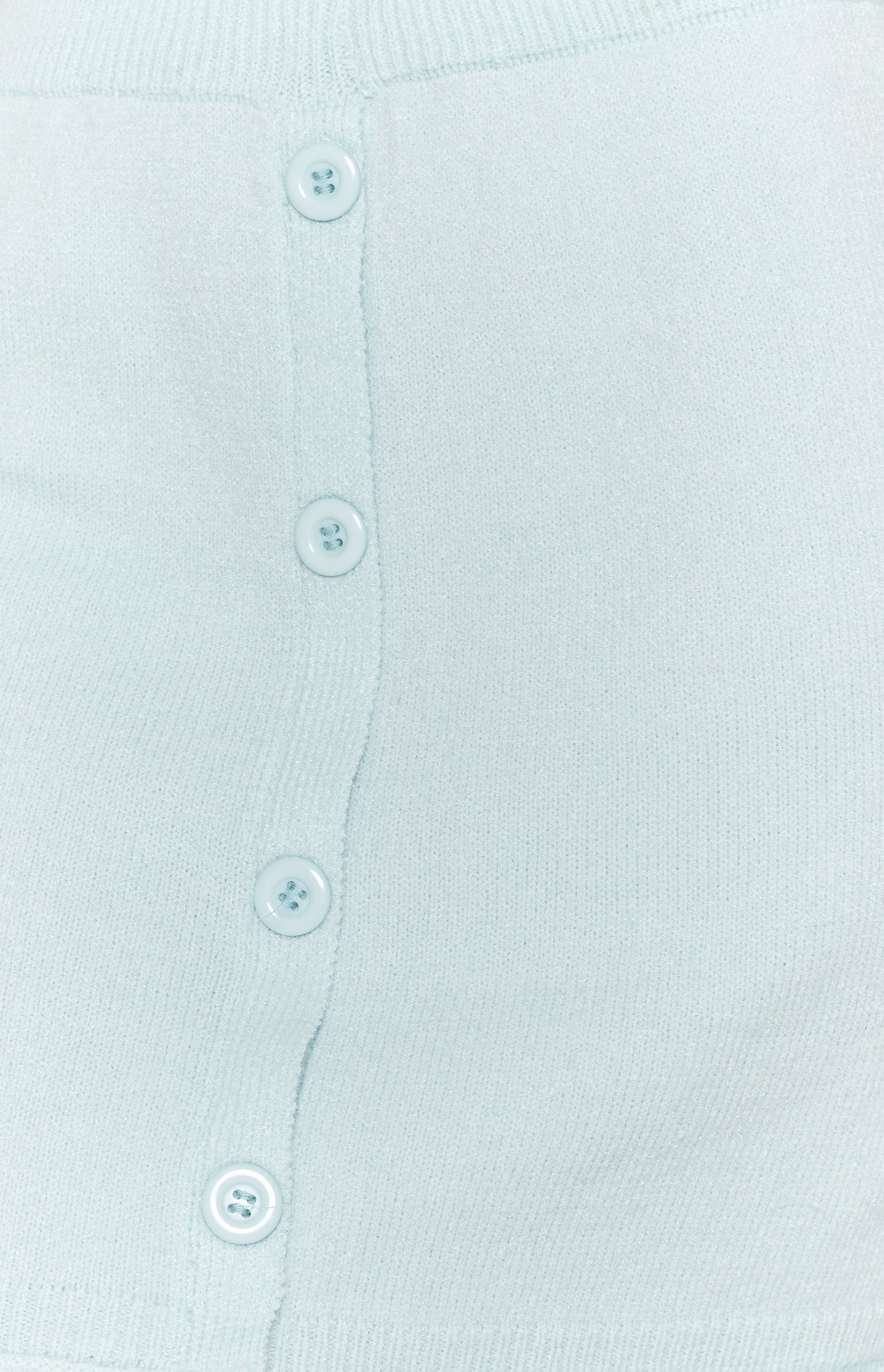 Soft light blue knit skirt fabric with a vertical row of four round matching buttons