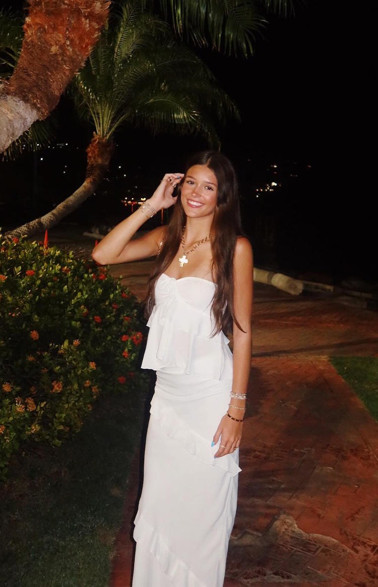 White strapless top with a tiered ruffle overlay and a relaxed fit