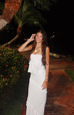 White strapless top with a tiered ruffle overlay and a relaxed fit